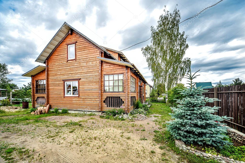 Rustic two-story wooden house, Country life in the summer. Russia