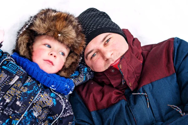 Young Father Son Fur Hat Lie Snow Winter Time Stock Photo