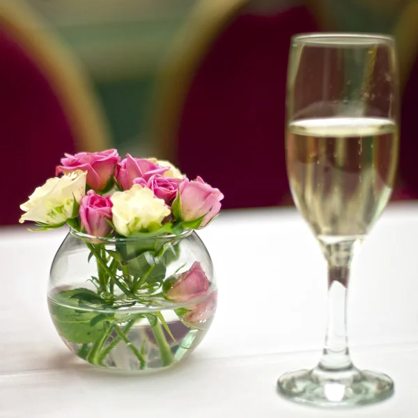 Ramo de rosas y copa de champán —  Fotos de Stock