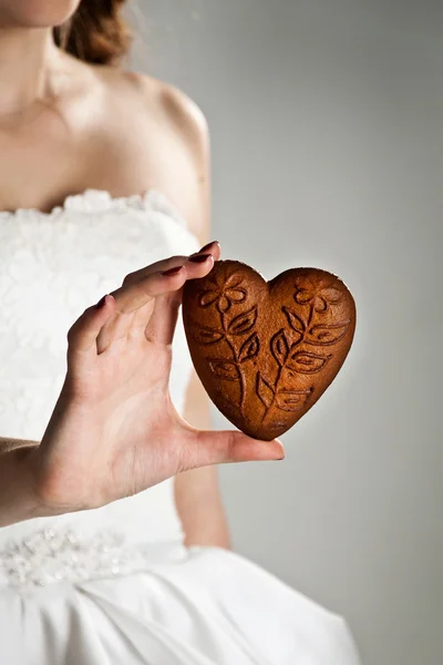 Heart shape in the hands of a young woman — Stock Photo, Image
