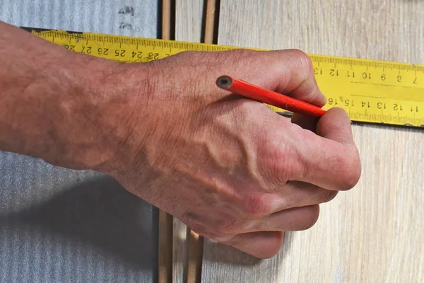 Hands of the carpenter measure closeup Stock Picture