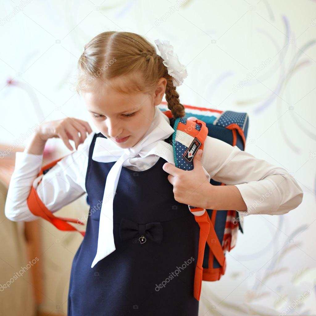 Youngest Schoolgirl wearing a backpack and going to school.
