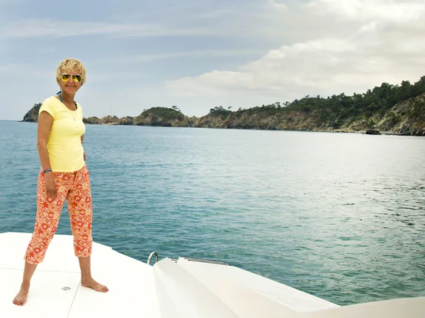 Happy middle-aged woman on vacation on a yacht — 스톡 사진