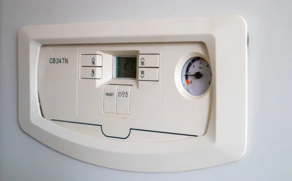 Internal control of a gas double-circuit boiler with a pressure and temperature sensor in the home heating system, close. Energy saving and image efficient home concept. Selective focus