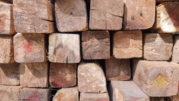 Yığınla kereste. Katlanmış odun. Kapalı ahşap tahtalar. Tahtanın yüzeyi. Depoda üst üste yığılmış kalaslar.