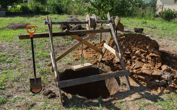 The process of digging a deep well in the ground, photo was taken on a sunny summer day — Stock Image Process Digging Deep Well Ground Photo Taken Sunny Summer Day Stock Photo