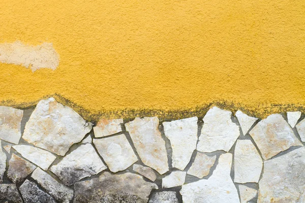 Yellow wall with stone — Stock Photo, Image