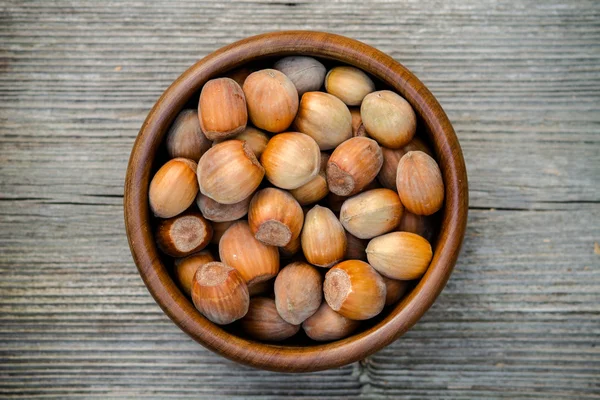 Nuts in a bowl - rustic wooden table — Stock fotografie