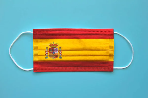 A face mask with a Spanish Flag on a clear background. Concept: Spain during pandemic.