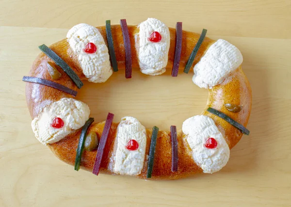 A top over view of A king cake or referred to as kingcake, kings' cake, king's cake, three kings' cake, or Twelfth Night cake.