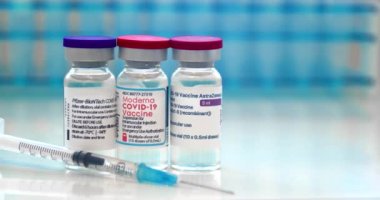 Calgary, Alberta, Canada. April 15, 2021. A health worker with Pfizer, Moderna, AstraZeneca and Janssen covid-19 vaccines. Concept: Choose which vaccine to get.