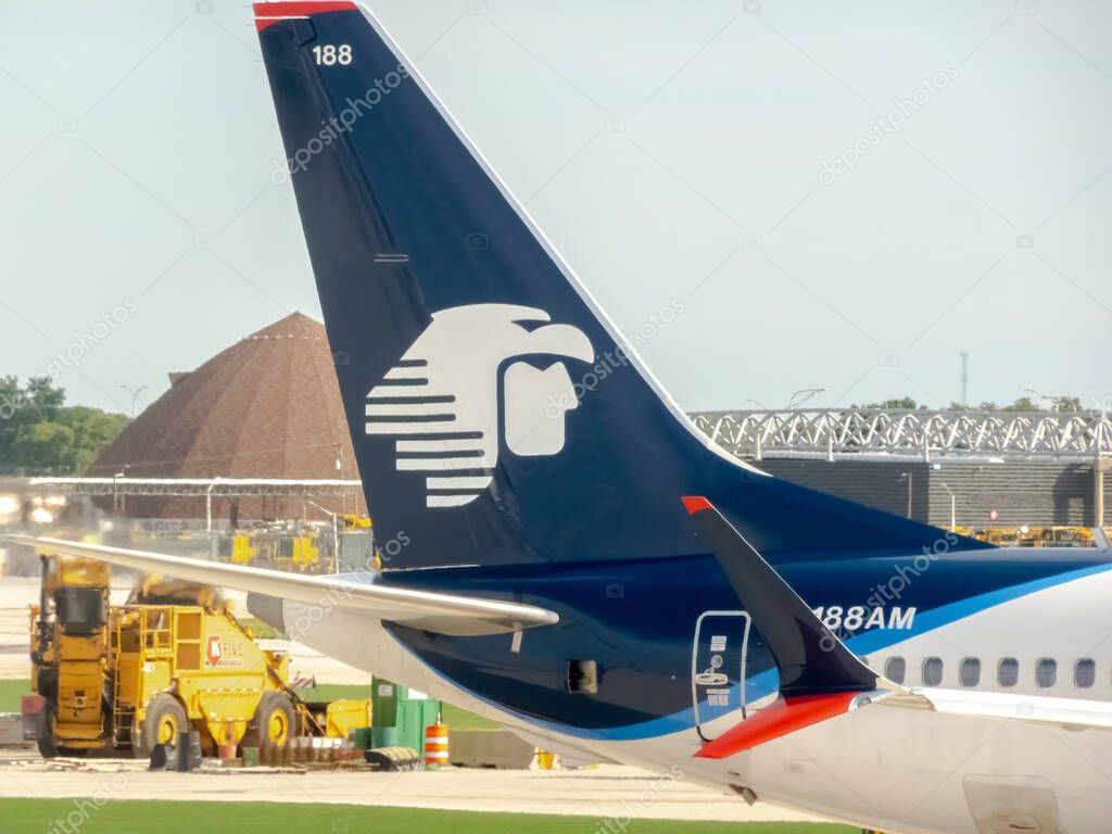 Chicago, Illinois, USA. Oct 16, 2025. The iconic Aeromexico eagle logo graces the tail of an airplane at an airport, symbolizing global travel and aviation.