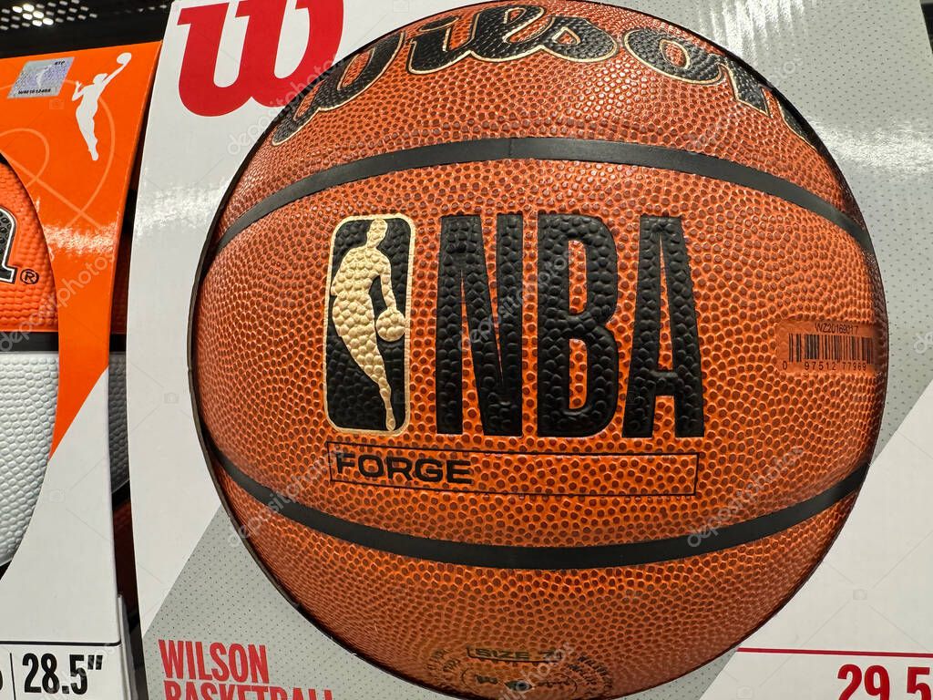 Calgary, Alberta, Canada. Nov 2, 2025. Wilson NBA FORGE 29.5 basketball in retail packaging with a 28.5 size visible nearby on shelf