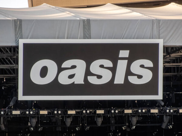 Chicago, Illinois, USA. Nov 11, 2025. Large "oasis" sign mounted above lighting rig on a concert stage at a music festival.