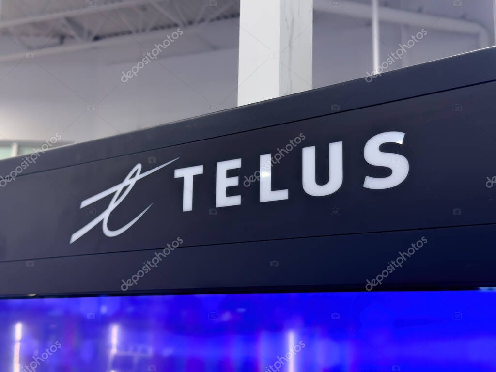 Calgary, Alberta, Canada. Nov 27, 2025. TELUS Communications Logo Sign on Green Wall inside a Retail Store Showroom.