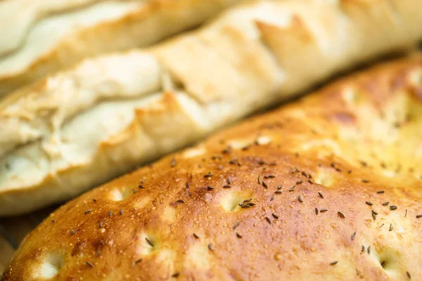 Fresh baguette and flat bread from the oven, close-up