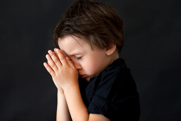 Little boy praying, child praying, isolated background