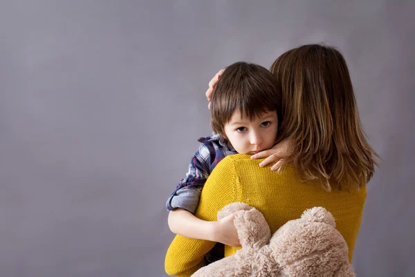 Bambino triste, ragazzo, abbracciare sua madre a casa — Foto Stock