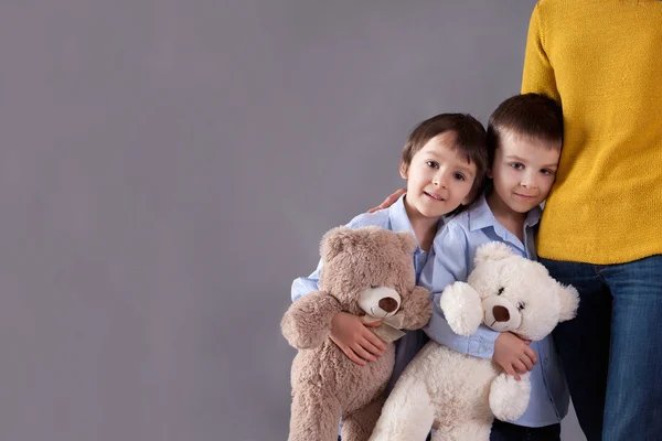 Happy little children, boys, hugging their mother at home, isola — Stock Photo, Image