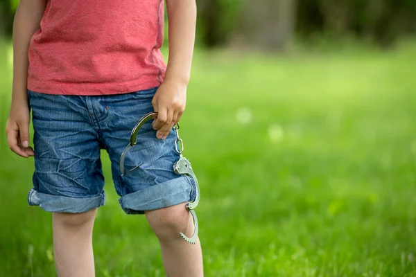 Cute little boy with the hand cuffs on his hands — Stock Photo, Image