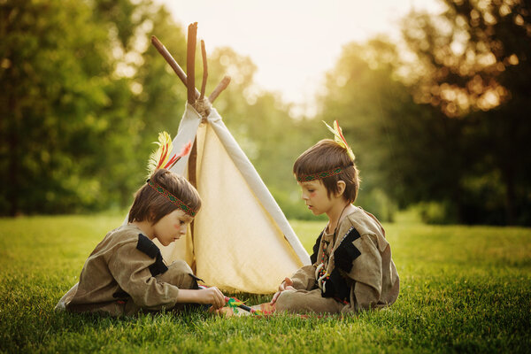 Cute portrait of native american boys with costumes, playing out