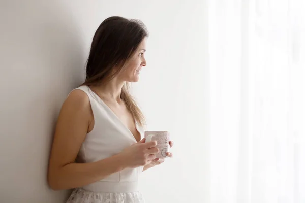 Middle Age Woman White Dress Drinking Coffee Home Looking Out — Stock Photo, Image