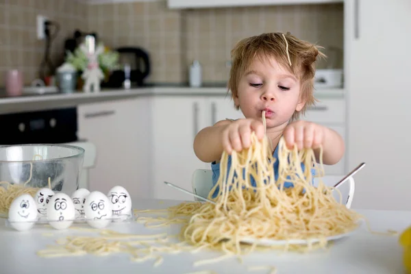 小さなブロンドの男の子 幼児の子供 昼食のためにスパゲティを食べて キッチンで家で混乱を作る — ストック写真