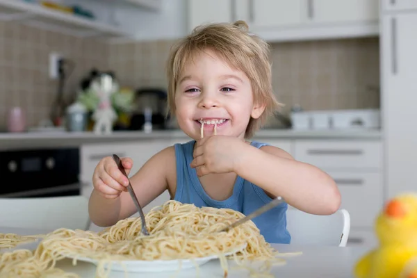 Little Blond Boy Toddler Child Eating Spaghetti Lunch Making Mess Stock Image
