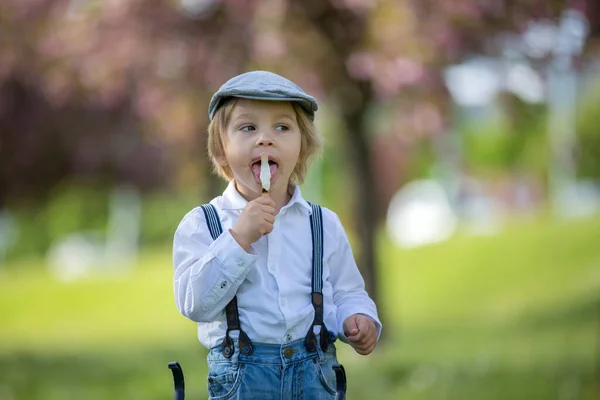 Модный Ребенок Ест Мороженое Толкает Детей Коляску Вязаной Куклой Парке — стоковое фото