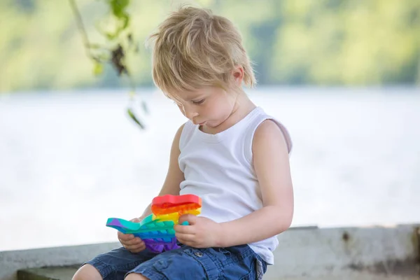 Little Toddler Child Blond Boy Playing Pop Antistress Toy Park — Stock Photo, Image