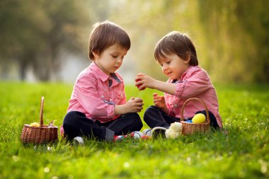 Having oyunculuk ile renkli yumurta Paskalya için iki erkek parkta,