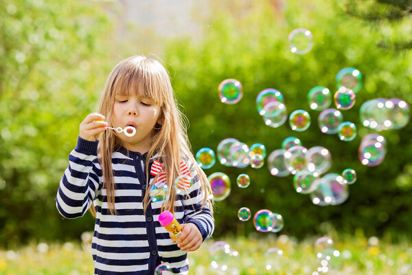 Beautiful little blonde girl, playing outdoor, springtime