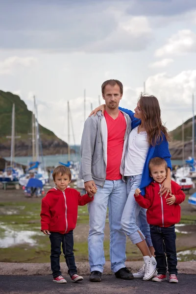 Молодая семья с маленькими детьми на гавани во второй половине дня — стоковое фото