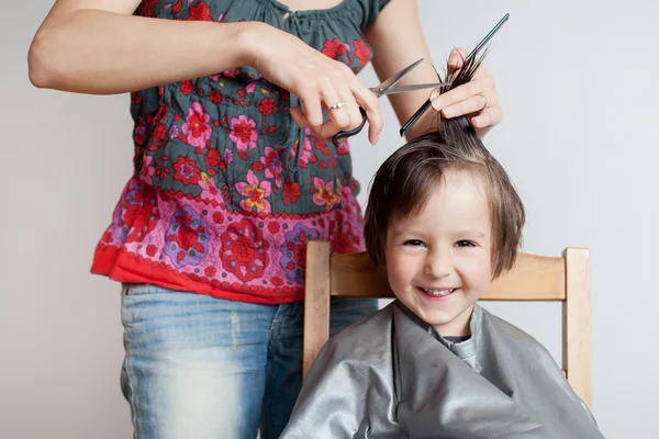 Cute little boy, having haircut, smiling happily — Stock Photo, Image