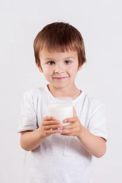 Cute little boy, drinking milk, holding glass of milk, mustaches — Stock Photo, Image