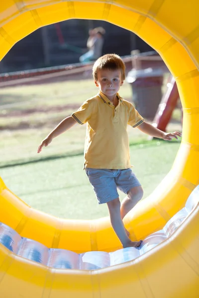 Cute little boy, playing in a rolling plastic cylinder ring, ful — Stock Photo, Image