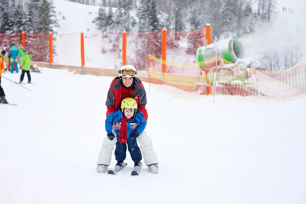 Beautiful young mom and her toddler boy, skiing in the mountains — Stock Photo, Image