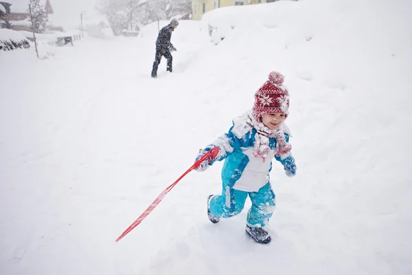 Cute little boy in blue winter suit, playing outdoor in the snow — Stock Photo, Image