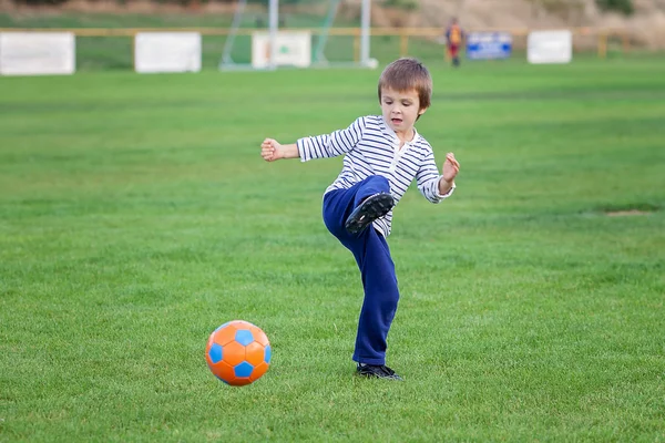 Little toddler boy playing soccer and football, having fun outdo — Zdjęcie stockowe