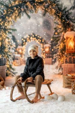 Noel 'de mutlu çocuk, hediyelerin, karın, Noel ışıklarının tadını çıkarıyor ve günün tadını çıkarıyor, kar, Noel, mutluluk.