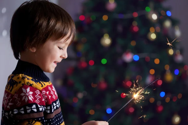 Beautiful Little child holding burning sparkler on New Year's Ev — Stock Photo, Image