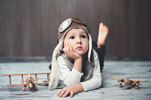 Young boy, playing with airplane Stock Picture