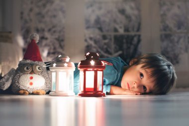 Mum seyir yere uzanmış güzel bir çocuk,