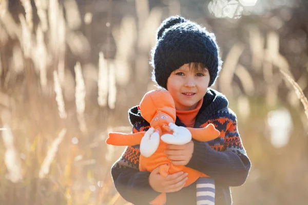 Cute little caucasian child, boy, holding fluffy toy, hugging it — Stock Photo, Image