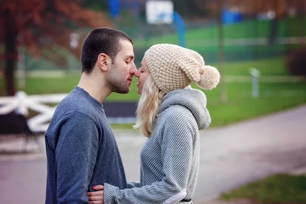 Young attractive couple in love, teenagers having fun outdoors, — Stock Photo, Image
