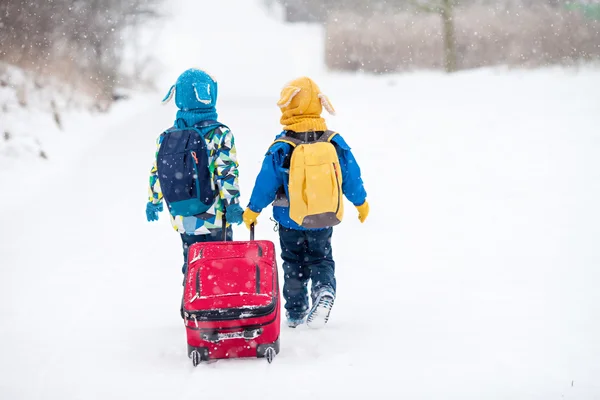 Dwa małe dzieci, bracia chłopiec z plecakami i duży czerwony s — Zdjęcie stockowe