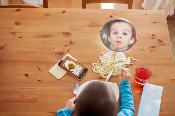 Sweet child, boy, having for lunch spaghetti at home, enjoying t — Stock Photo, Image