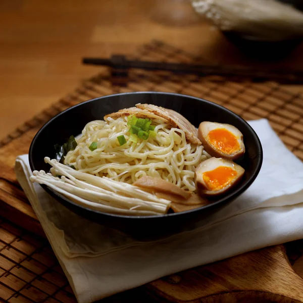 Close up view of traditional Japan noodle, Tonkotsu ramen with sliced pork and eggs and pork bone based soup on wooden table