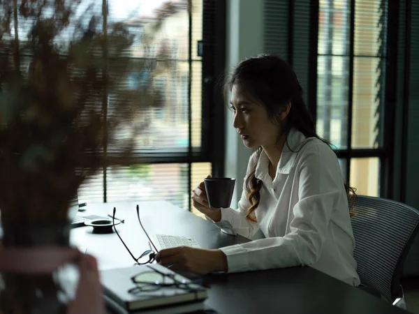 Portrait of businesswoman take a break with coffee while working in office room