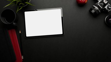 Dijital tablet, kamera, malzeme ve kopyalama alanı, kırpma yolu, üst görünümü olan karanlık yaratıcı düz çalışma alanı